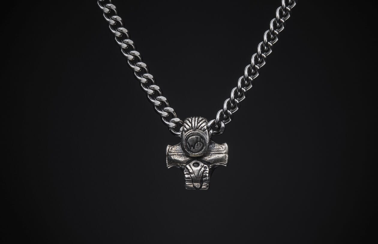 Silver-toned curb chain necklace with a detailed Norse-inspired hammer pendant.