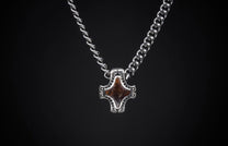 Silver necklace featuring two distinct chain styles and a stylized brown stone pendant.