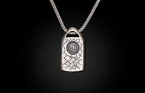 Silver necklace with a textured rectangular pendant featuring a circular "WH" emblem, on a braided chain.