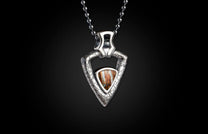Silver textured triangular pendant necklace with a central brown striped stone, suspended from a ball chain.
