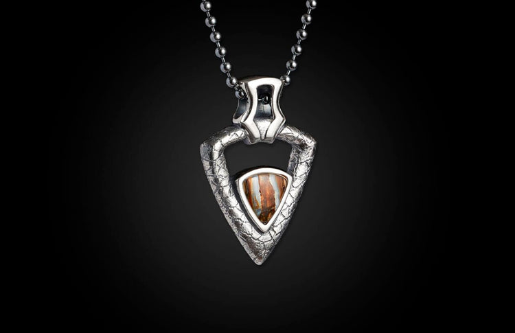 Silver textured triangular pendant necklace with a central brown striped stone, suspended from a ball chain.