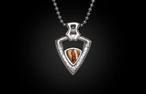 Silver-toned arrowhead pendant with a textured metal frame and a striped brown, orange, and white stone, hanging on a ball chain.