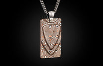 Rectangular Mokume Gane pendant necklace with swirling brown, white, and black patterns, hanging from a silver chain.