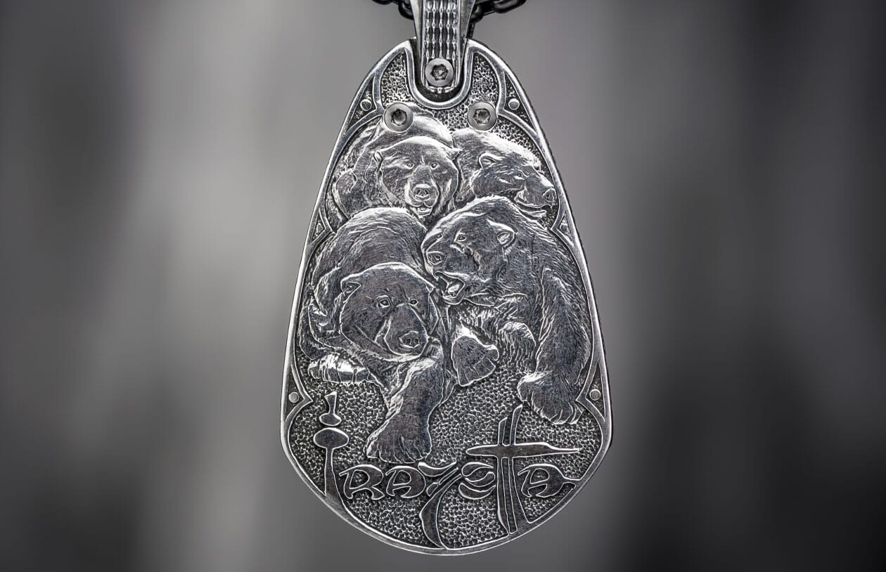 Silver metal pendant featuring four detailed relief bears, a textured background, and stylized "RAVE" text with a cross.