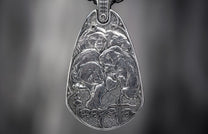 Silver metal pendant featuring four detailed relief bears, a textured background, and stylized "RAVE" text with a cross.