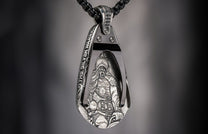 Silver pendant featuring an intricately detailed warrior figure and "THE SILVER WARRIOR" text on a black chain.