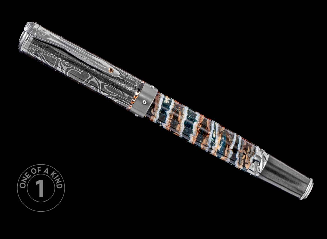 One of a Kind custom pen from William Henry featuring a fossil mammoth tooth barrel, hand forged Damascus steel cap, Smoky Quartz gemstone, and titanium accents.