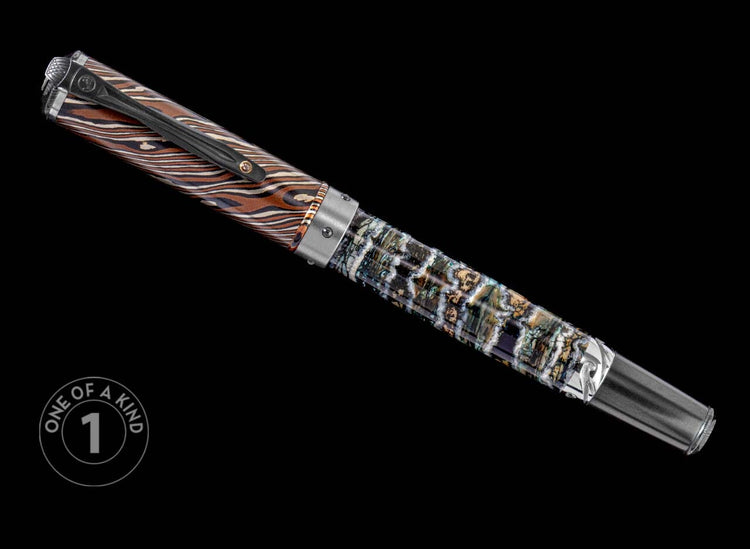 One of a Kind pen from William Henry featuring a fossil mammoth tooth barrel, Mokume Gane cap, smoky quartz gemstone, and titanium accents.