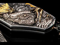This engraving by Vlastik Petak is a story of the Okavango Delta. This VERY complex and elaborate engraving features a full palette of engraving techniques: photo realistic bulino work for the hippos, 3D sculpting for animals, LOTS of gold inlay, including highly sculpted 18K green gold for the grass and generous and tasteful use of 24K gold across the piece. Love the antelope in silhouette against a gold moon! Black diamonds and Robert Eggerling hand-forged damascus blade complete this exquisite piece.
