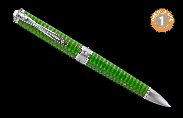 Angled green pen with a textured scale pattern, silver clip, cap, and tip.