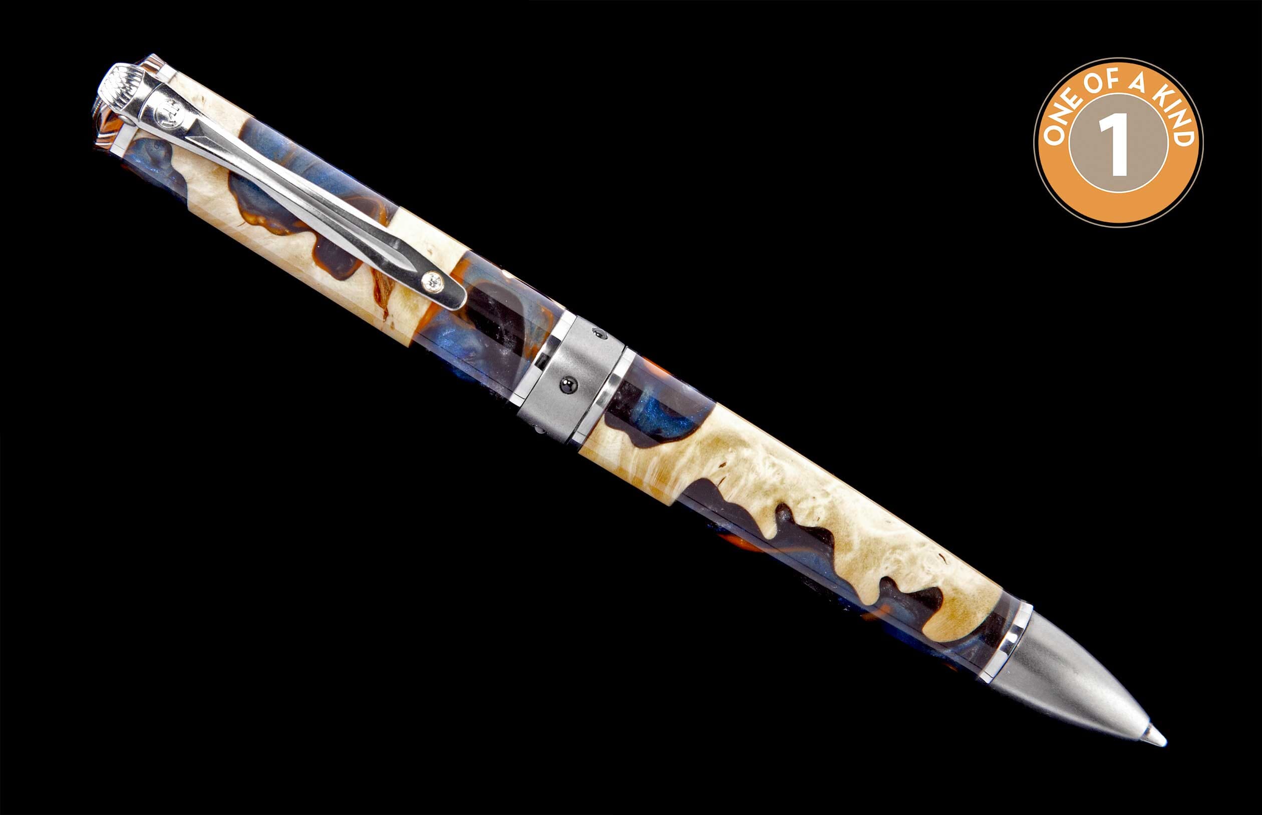 Pen with a light burl wood and dark blue swirling resin barrel, accented by silver-tone hardware and a 'One of a Kind' emblem.