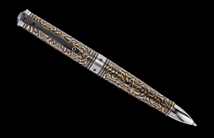 Ornate pen with a dark body and intricate gold scrollwork, featuring a silver-toned clip and writing tip.