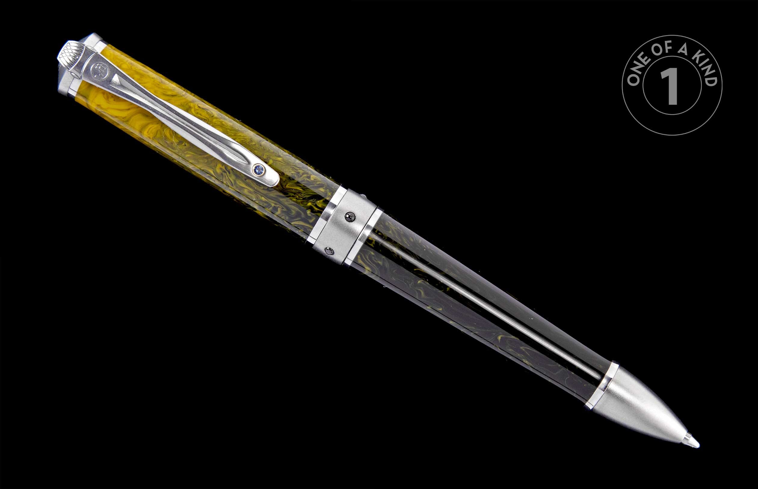 Pen with a yellow and black marbled body, silver-toned metal accents, and a blue jewel on its clip.