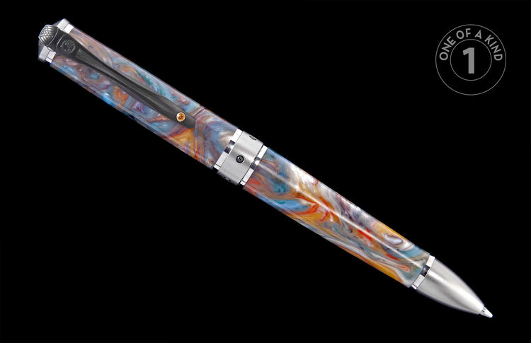 Pen with a swirling body of blue, orange, gold, and white resin, featuring a silver-toned clip and tip. A 'ONE OF A KIND' graphic is visible.