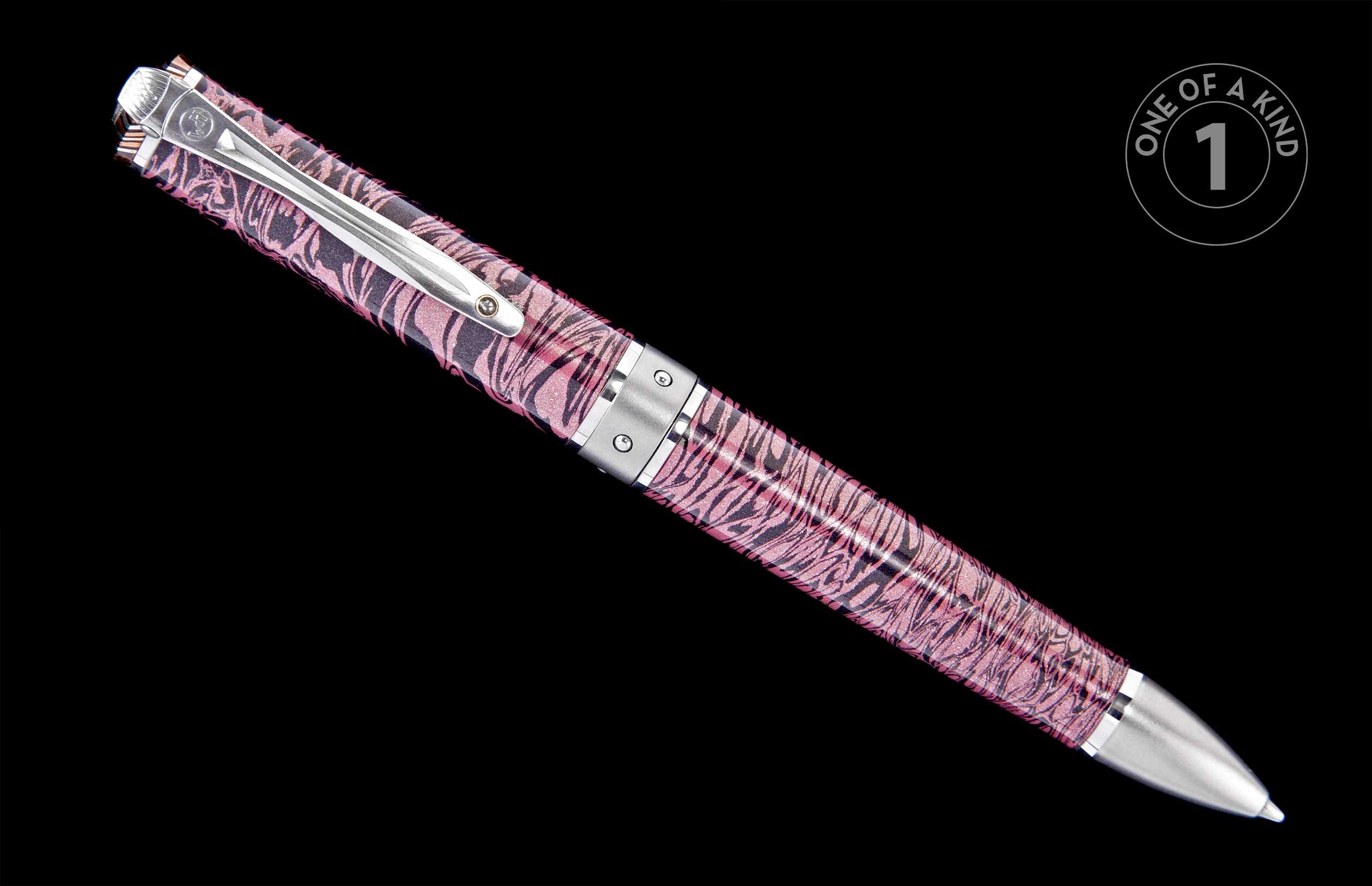 Glittery pink and black abstract patterned pen with silver-tone hardware, displayed at an angle.