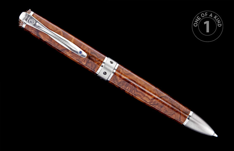 Elegant brown burl wood pen with silver-toned metal accents and a blue gemstone on the clip, angled.