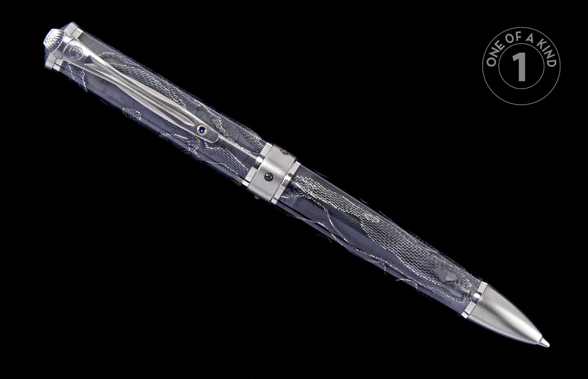 Elegant silver-toned pen with a transparent patterned barrel, featuring a decorative clip with a blue gem.