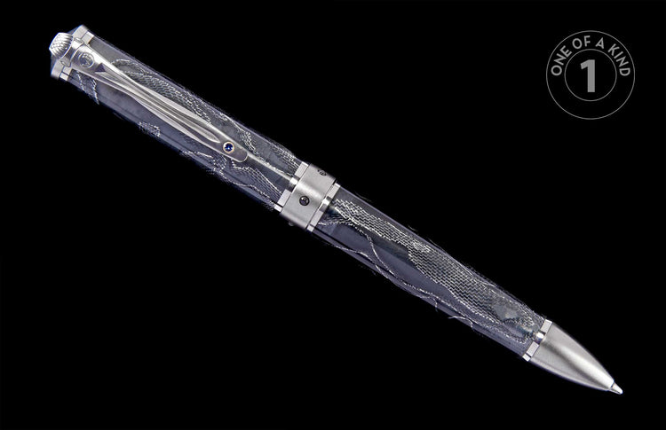 Elegant silver-toned pen with a transparent patterned barrel, featuring a decorative clip with a blue gem.