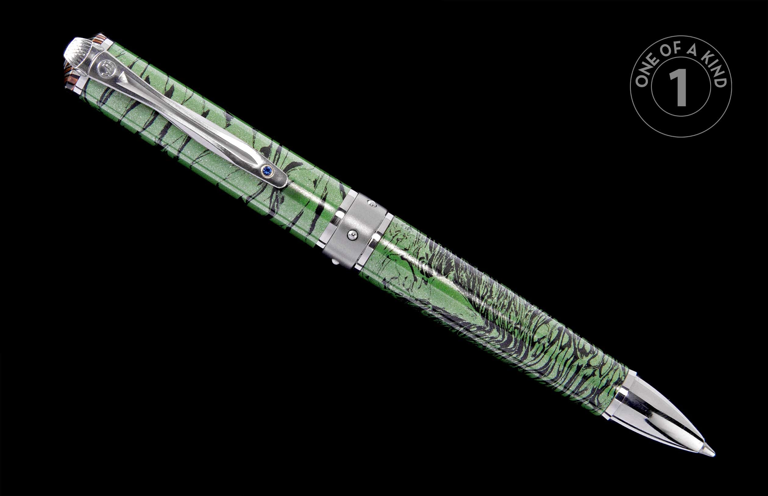 Green and black marbled pen with a silver clip featuring a blue jewel, displayed diagonally against a black background.