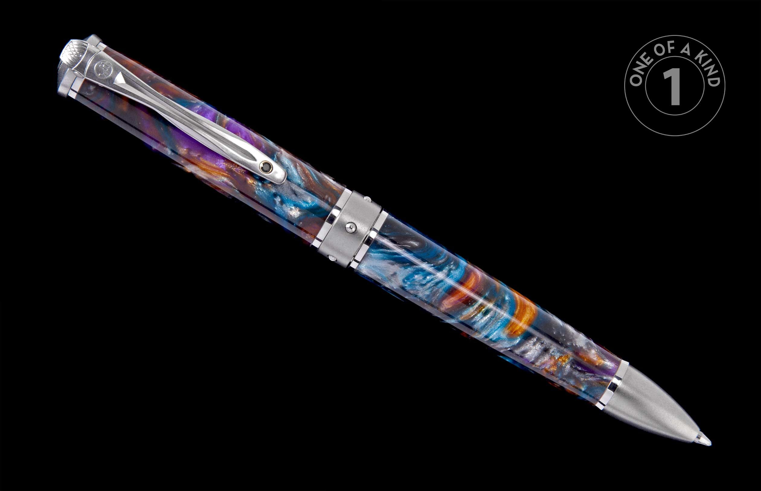 Swirled resin ballpoint pen in vibrant purple, blue, and orange with silver-toned metal accents and clip, displayed on a black background.