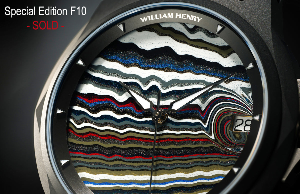 Fordite dial watch by William Henry, featuring layered multicolor marbled pattern, black hands, date window, and textured bezel in close-up view