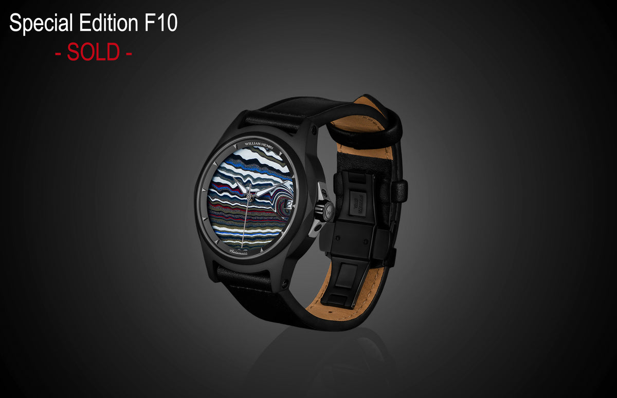 Special Edition Fordite watch by William Henry with multicolored marbled dial, black case, and leather strap, side view