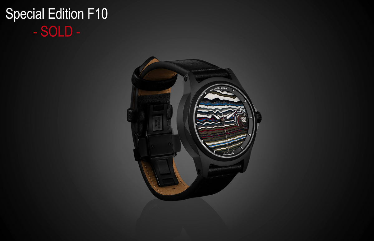Special edition Fordite dial watch by William Henry, black case with multicolored layered pattern, black leather strap, side view