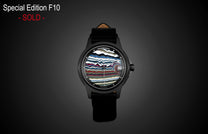 Special Edition Fordite watch by William Henry with multicolored striped dial, black case, and leather strap, front view