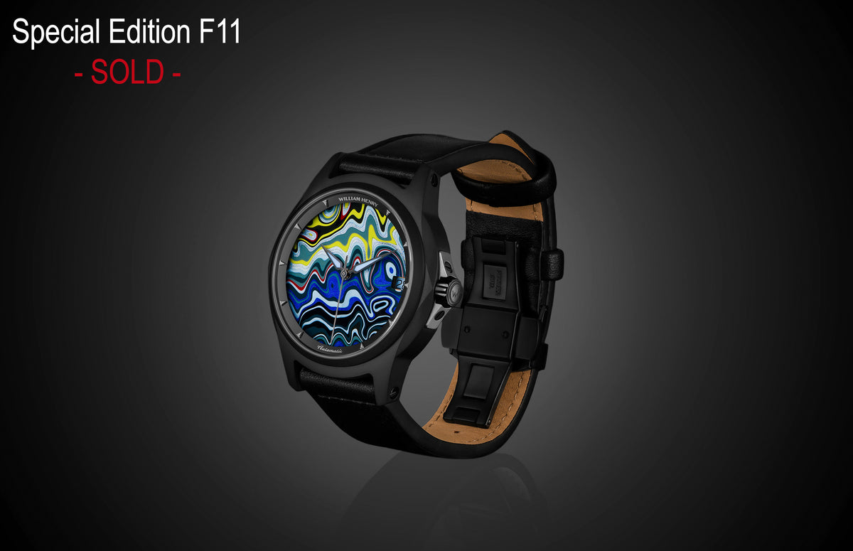 Special Edition Fordite watch by William Henry with vibrant marbled dial, black case, and leather strap, side view on dark background