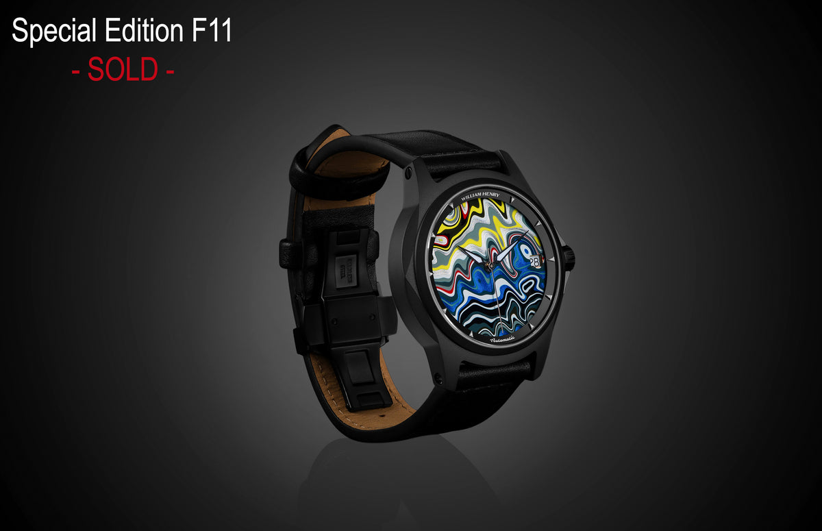Special Edition Fordite watch by William Henry with vibrant marbled dial, black case, and leather strap, side view on dark background