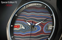 Special edition Fordite dial watch by William Henry, featuring vibrant red, blue, and white marbled texture with polished silver hands and date window, close-up view