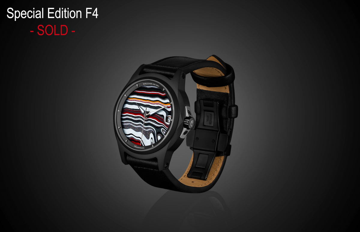 Black automatic watch with vibrant Fordite dial by William Henry, featuring layered red, white, and black patterns, black leather strap with tan lining, side view on dark background.