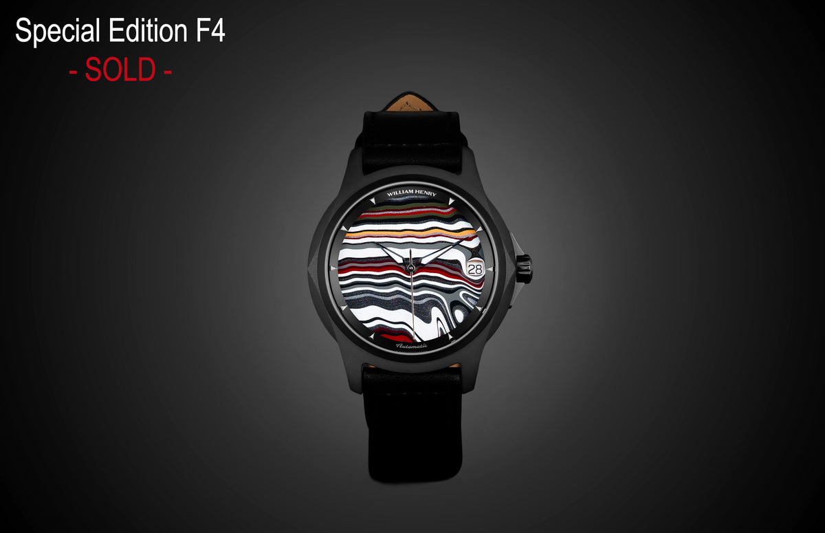 Fordite dial automatic watch by William Henry with black case and leather strap, featuring vibrant striped pattern and date window, front view