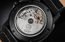 Black limited edition watch back by William Henry, showcasing intricate mechanical movement, brushed metal rotor, and sapphire crystal display.