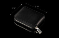 ZBF LIZ BLK MT|Black leather bi-fold wallet with a textured scale pattern, featuring a silver zipper and pull tab.